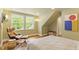 Cozy bedroom featuring wood floors, a comfortable chair, and large windows for ample natural light at 2140 N Lakeshore Dr, Chapel Hill, NC 27514