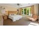 Bedroom with large windows letting in natural light, neutral walls, and a fan at 2140 N Lakeshore Dr, Chapel Hill, NC 27514