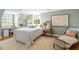 Inviting bedroom with soft colors, desk area, a sitting chair, and natural light from two windows at 2140 N Lakeshore Dr, Chapel Hill, NC 27514