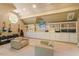 Large bonus room with custom built-in shelving, cabinets, and sitting area with instruments at 2140 N Lakeshore Dr, Chapel Hill, NC 27514
