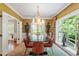 Dining room with modern chandelier, views of the front yard, and seating for six at 2140 N Lakeshore Dr, Chapel Hill, NC 27514