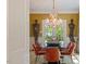 Dining room featuring a glass table, stylish chandelier, and unique art pieces at 2140 N Lakeshore Dr, Chapel Hill, NC 27514