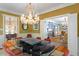 Open dining area with ornate chandelier, wood flooring, and access to multiple living spaces at 2140 N Lakeshore Dr, Chapel Hill, NC 27514