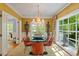 Dining room with modern chandelier and stylish decor overlooking picturesque backyard at 2140 N Lakeshore Dr, Chapel Hill, NC 27514