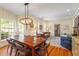 Large dining room with wood floors, wainscoting, and a view into the comfortable living room at 2140 N Lakeshore Dr, Chapel Hill, NC 27514