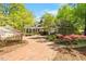 Beautiful home with brick driveway and lush landscaping, featuring a mix of architectural styles and a well-maintained garden at 2140 N Lakeshore Dr, Chapel Hill, NC 27514
