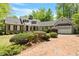 Charming brick home with a two-car garage, beautiful landscaping, and a red brick driveway at 2140 N Lakeshore Dr, Chapel Hill, NC 27514