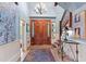 Grand foyer featuring custom double doors, elegant chandelier, staircase, and eye-catching decor and artwork at 2140 N Lakeshore Dr, Chapel Hill, NC 27514