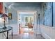 Inviting foyer with blue walls, paneled wainscoting, decorative table, tile floors, and arched doorway at 2140 N Lakeshore Dr, Chapel Hill, NC 27514