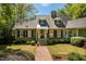 Charming brick home with a landscaped front yard, and a brick pathway to the front door at 2140 N Lakeshore Dr, Chapel Hill, NC 27514