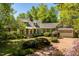 Charming home with manicured lawn, brick pathway, and mature trees at 2140 N Lakeshore Dr, Chapel Hill, NC 27514