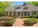 Charming brick home with a manicured lawn and beautiful landscaping, offering classic curb appeal at 2140 N Lakeshore Dr, Chapel Hill, NC 27514