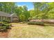 Charming home exterior with lush front yard, brick path and manicured landscaping at 2140 N Lakeshore Dr, Chapel Hill, NC 27514
