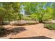 Well maintained lush front yard featuring a brick patio, flowers, and shrubbery at 2140 N Lakeshore Dr, Chapel Hill, NC 27514