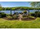 Lakeside gazebo surrounded by lush landscaping, perfect for relaxing and entertaining at 2140 N Lakeshore Dr, Chapel Hill, NC 27514