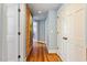 Hallway with wood floors, brick wall, and doors at 2140 N Lakeshore Dr, Chapel Hill, NC 27514