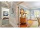 Inviting hallway featuring hardwood floors, decorative mirror and views into other rooms at 2140 N Lakeshore Dr, Chapel Hill, NC 27514