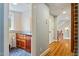 Hallway view featuring hardwood floors and custom built in cabinet with drawers at 2140 N Lakeshore Dr, Chapel Hill, NC 27514