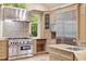 Well-equipped kitchen featuring stainless steel appliances, mosaic backsplash, and granite countertops at 2140 N Lakeshore Dr, Chapel Hill, NC 27514