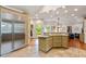Open kitchen featuring stainless steel refrigerator, tiled floors, and access to backyard at 2140 N Lakeshore Dr, Chapel Hill, NC 27514