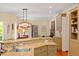 Open-concept kitchen with granite countertops, stainless steel appliances, and wood flooring at 2140 N Lakeshore Dr, Chapel Hill, NC 27514