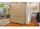 Bright kitchen with stainless steel appliances and hardwood floors adjacent to cabinetry at 2140 N Lakeshore Dr, Chapel Hill, NC 27514