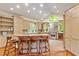 Bright kitchen featuring custom cabinets, stainless appliances, a breakfast bar, and stylish bar stools at 2140 N Lakeshore Dr, Chapel Hill, NC 27514