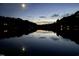 Scenic lake view at dusk with reflections and trees silhouetted against the sky and full moon at 2140 N Lakeshore Dr, Chapel Hill, NC 27514