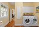 Laundry room with front load washer and dryer, and lots of storage at 2140 N Lakeshore Dr, Chapel Hill, NC 27514