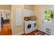 Functional laundry room with washer, dryer, and built-in storage near an outdoor access at 2140 N Lakeshore Dr, Chapel Hill, NC 27514