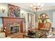 Living room featuring a fireplace, chandelier, and hardwood floors at 2140 N Lakeshore Dr, Chapel Hill, NC 27514