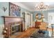 Charming living room with a brick fireplace, hardwood floors, and elegant decor at 2140 N Lakeshore Dr, Chapel Hill, NC 27514