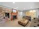 Cozy living room featuring a brick fireplace with a wooden mantle and comfortable seating at 2140 N Lakeshore Dr, Chapel Hill, NC 27514