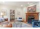 Bright living room featuring a fireplace, wood floors, stairs to the second floor, and modern decor at 2140 N Lakeshore Dr, Chapel Hill, NC 27514