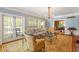 Cozy living room with hardwood floors, chandelier, and a view into dining room at 2140 N Lakeshore Dr, Chapel Hill, NC 27514