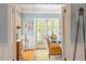 Cozy living room featuring hardwood floors, wainscoting, and natural light from the large windows at 2140 N Lakeshore Dr, Chapel Hill, NC 27514