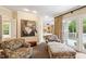 Bright main bedroom including sitting area, with access to the outside at 2140 N Lakeshore Dr, Chapel Hill, NC 27514