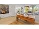 A home office space featuring a large wooden desk in front of a window and neutral decor at 2140 N Lakeshore Dr, Chapel Hill, NC 27514