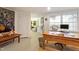Home office with natural light from the windows and a large wooden desk at 2140 N Lakeshore Dr, Chapel Hill, NC 27514
