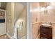 Charming powder room with patterned wallpaper and antique-style vanity at 2140 N Lakeshore Dr, Chapel Hill, NC 27514