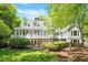 Charming home features a sunroom, white trim windows, and professionally landscaped yard at 2140 N Lakeshore Dr, Chapel Hill, NC 27514