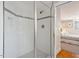 Modern shower with glass enclosure, white tile with black accents, and a built-in niche at 2140 N Lakeshore Dr, Chapel Hill, NC 27514