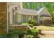 Stylish home exterior featuring a combination of brick and siding, with professionally landscaped gardens at 2140 N Lakeshore Dr, Chapel Hill, NC 27514