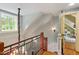 Staircase foyer with wood and iron railing, hardwood steps, and a bright window providing natural light at 2140 N Lakeshore Dr, Chapel Hill, NC 27514