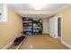 Basement storage room with exercise equipment and storage shelves for organizing items at 2140 N Lakeshore Dr, Chapel Hill, NC 27514