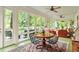 Bright sunroom with access to porch, many windows, and vaulted ceiling at 2140 N Lakeshore Dr, Chapel Hill, NC 27514