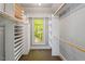 A walk-in closet with custom shelving, wooden poles, and a window at 2140 N Lakeshore Dr, Chapel Hill, NC 27514