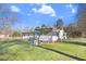 Large grassy backyard with a screened in porch and a fenced in yard at 2246 Arrowhead Rd, Dunn, NC 28334