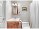 Functional bathroom with white toilet and wood vanity at 2246 Arrowhead Rd, Dunn, NC 28334