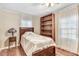 A cozy bedroom features natural light and wood-style flooring at 2246 Arrowhead Rd, Dunn, NC 28334
